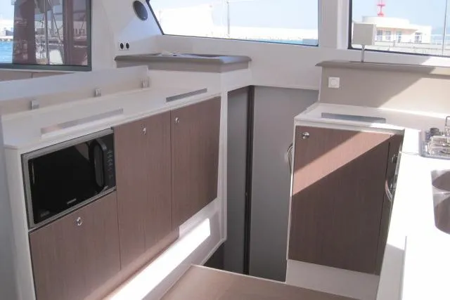  Yacht Photos Pics Modern kitchen interior of 2020 Bali 4.3 yacht with wood cabinets and appliances.