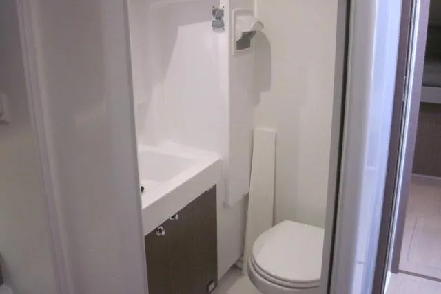  Yacht Photos Pics Compact bathroom in a 2020 Bali 4.3 model, featuring a toilet and sink.