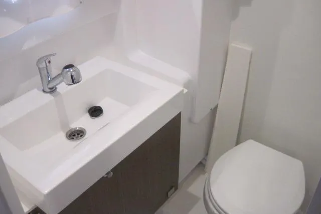  Yacht Photos Pics Compact bathroom with sink and toilet in a 2020 Bali 4.3 model.