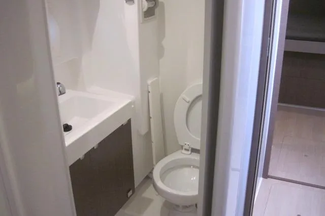  Yacht Photos Pics Compact bathroom in a 2020 Bali 4.3 model, featuring a toilet and sink.