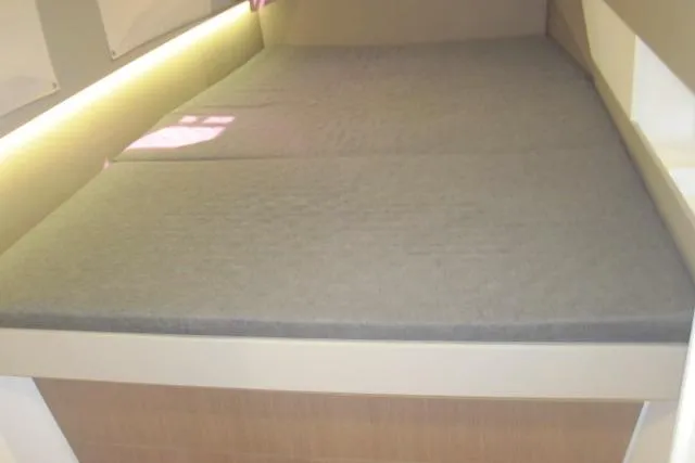  Yacht Photos Pics Cozy cabin bed in a 2020 Bali 4.3 yacht, featuring soft lighting and a comfortable mattress.