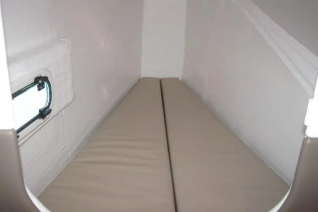  Yacht Photos Pics Compact sleeping area in a 2020 Bali 4.3 model, featuring a narrow bed and small window.