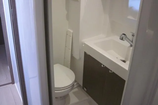  Yacht Photos Pics Compact bathroom in a 2020 Bali 4.3 model, featuring a toilet and sink.