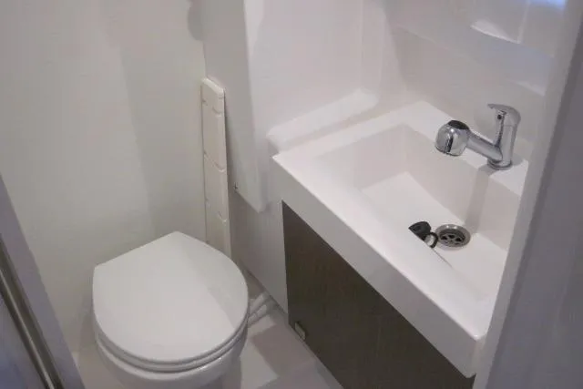  Yacht Photos Pics Compact bathroom in a 2020 Bali 4.3 model, featuring a toilet and sink.