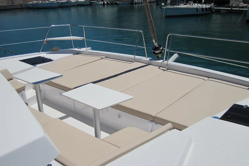  Yacht Photos Pics Luxurious 2020 Bali 4.3 catamaran deck with sun loungers and tables, docked in marina.