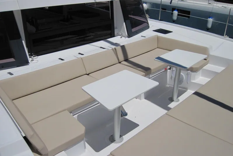  Yacht Photos Pics Luxurious seating area on a 2020 Bali 4.3 catamaran with beige cushions and white tables.