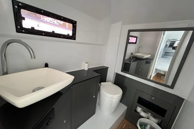 Pirelli 42 Yacht Photos Pics Modern bathroom interior in a 2021 Pirelli P Zero 42 boat, featuring sink and toilet.