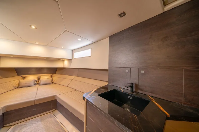 Cobra Yacht Photos Pics Luxurious interior of 2022 Vanquish Yachts VQ45 with elegant seating and modern sink.