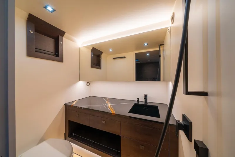 Cobra Yacht Photos Pics Luxurious bathroom interior of 2022 Vanquish Yachts VQ45 with modern fixtures and elegant design.