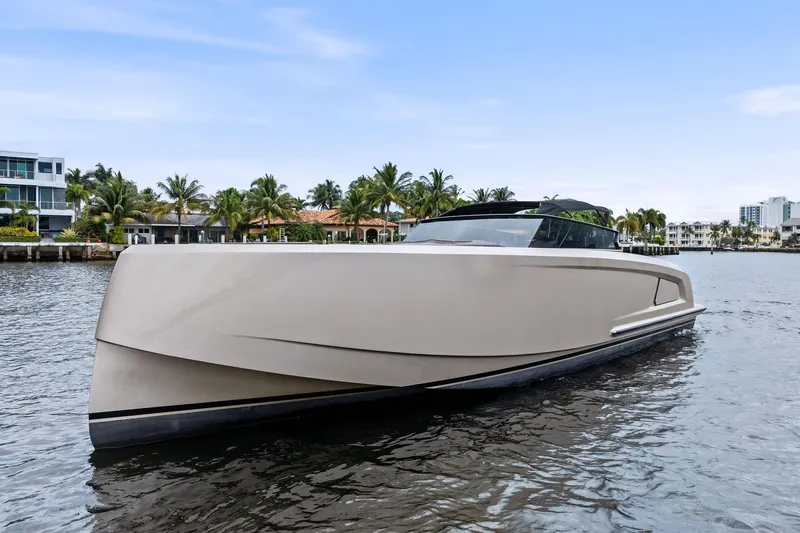 Cobra Yacht Photos Pics 2022 Vanquish Yachts VQ45 luxury yacht on calm water, modern design, waterfront homes in background.