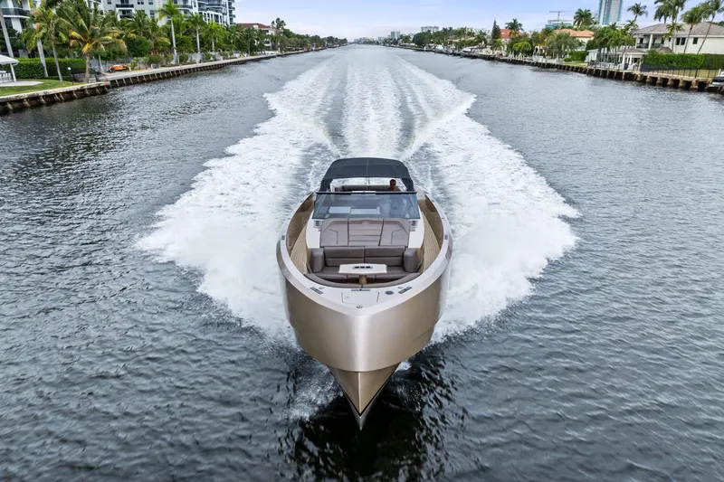 Cobra Yacht Photos Pics 2022 Vanquish Yachts VQ45 cruising on a scenic waterway, showcasing sleek design and luxury.
