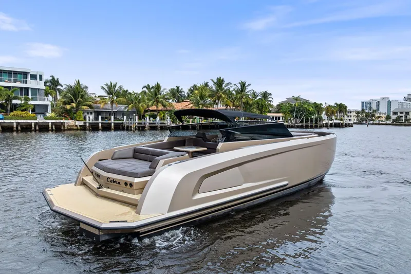 Cobra Yacht Photos Pics 2022 Vanquish Yachts VQ45 luxury yacht cruising on a scenic waterfront.