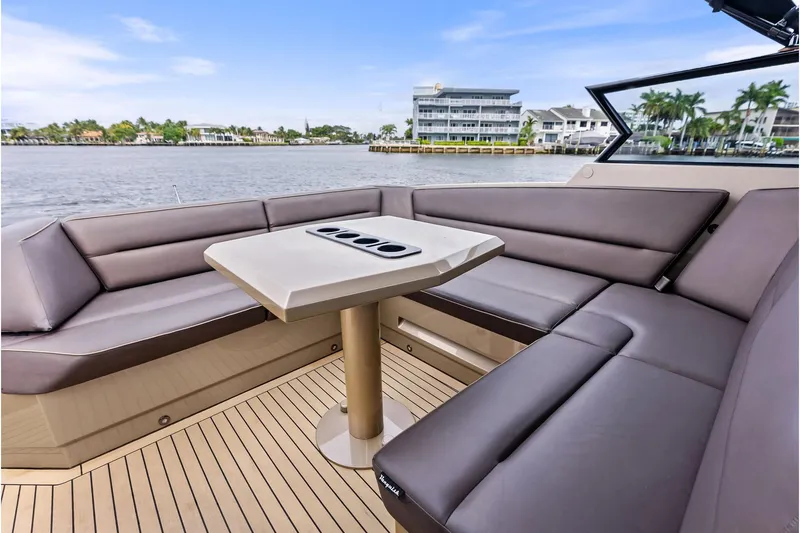 Cobra Yacht Photos Pics Luxurious 2022 Vanquish Yachts VQ45 interior with sleek seating and waterfront view.