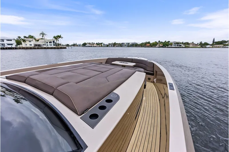 Cobra Yacht Photos Pics 2022 Vanquish Yachts VQ45 luxury yacht with sleek deck design on calm waters.