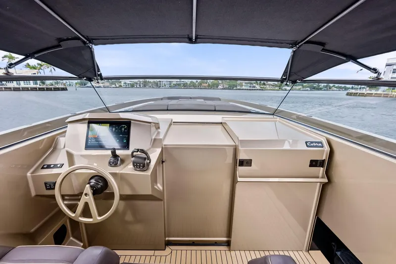 Cobra Yacht Photos Pics 2022 Vanquish Yachts VQ45 helm with modern controls and sleek design on open water.