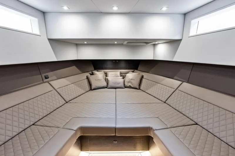 Cobra Yacht Photos Pics Luxurious interior of 2022 Vanquish Yachts VQ45 with elegant seating and cushions.