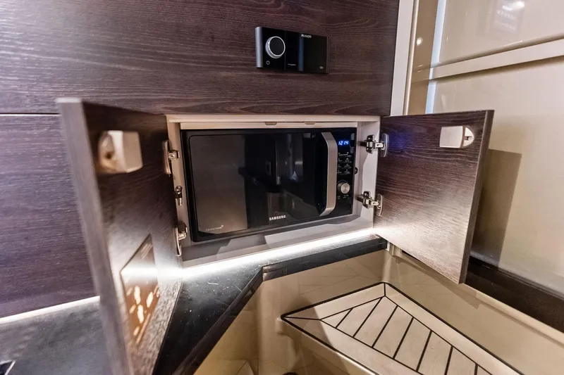 Cobra Yacht Photos Pics Microwave in 2022 Vanquish Yachts VQ45, sleek wooden cabinetry, modern kitchen design.