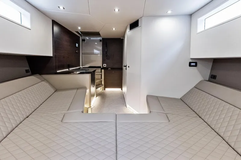 Cobra Yacht Photos Pics Luxurious interior of 2022 Vanquish Yachts VQ45 with modern seating and kitchenette.