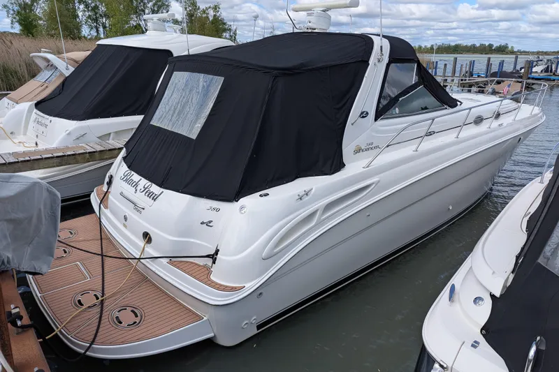 Black Pearl Yacht Photos Pics 1999 Sea Ray 380 Sundancer yacht docked with black canopy.