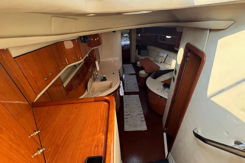 Rose Yacht Photos Pics Luxurious interior of 2001 Sea Ray 540 Sundancer yacht with wood finishes and cozy seating.