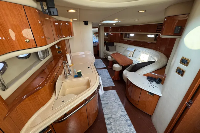 Rose Yacht Photos Pics Luxurious interior of 2001 Sea Ray 540 Sundancer yacht with elegant wood finishes.