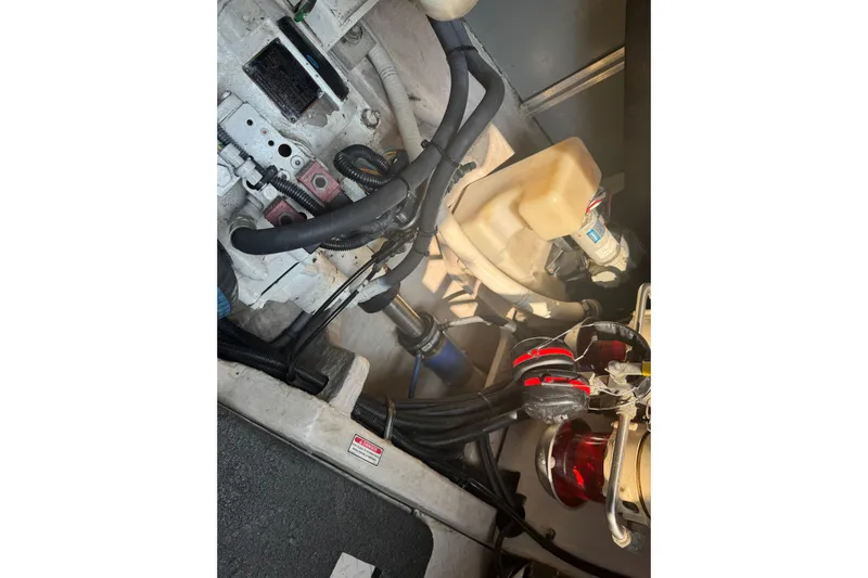 Rose Yacht Photos Pics Engine compartment of a 2001 Sea Ray 540 Sundancer boat, showing hoses and components.