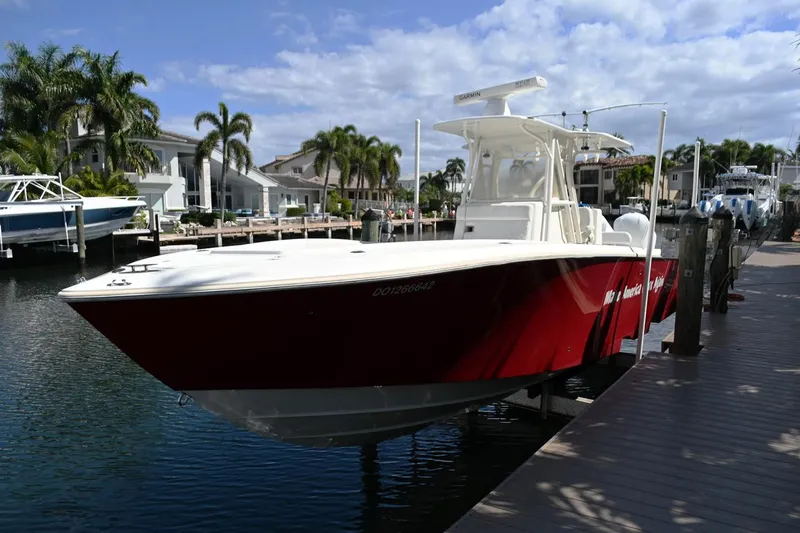 Yacht Photos Pics 2016 SeaVee 340Z boat docked in a marina, featuring a sleek red hull.