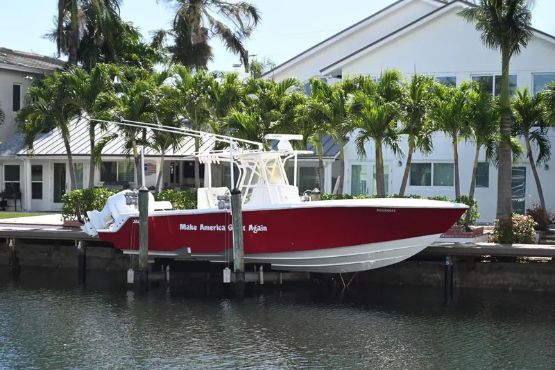 Yacht Photos Pics 2016 SeaVee 340Z boat docked by waterfront home, surrounded by palm trees.