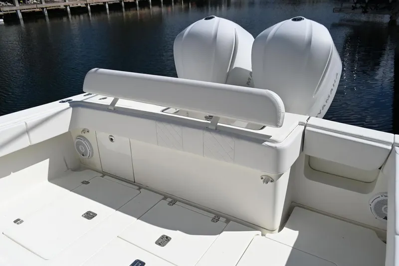  Yacht Photos Pics 2016 SeaVee 340Z boat deck with dual outboard engines, white seating, and storage compartments.