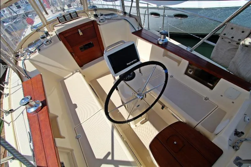  Yacht Photos Pics 1999 Island Packet 380 sailboat cockpit with steering wheel and navigation equipment.