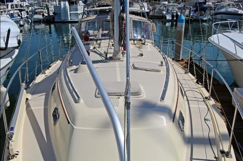  Yacht Photos Pics 1999 Island Packet 380 sailboat docked in a marina, showcasing its deck and rigging.