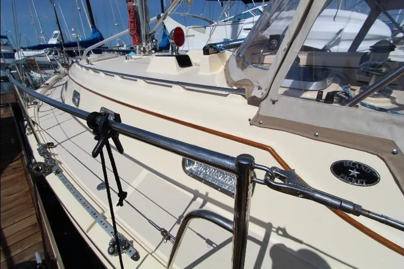  Yacht Photos Pics 1999 Island Packet 380 sailboat docked, showcasing deck and railing details.