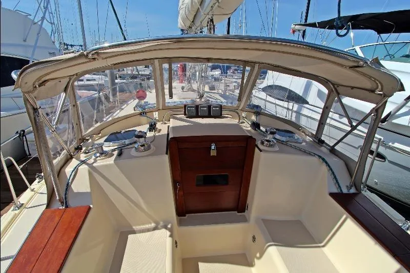  Yacht Photos Pics 1999 Island Packet 380 sailboat cockpit with wooden accents and marina view.