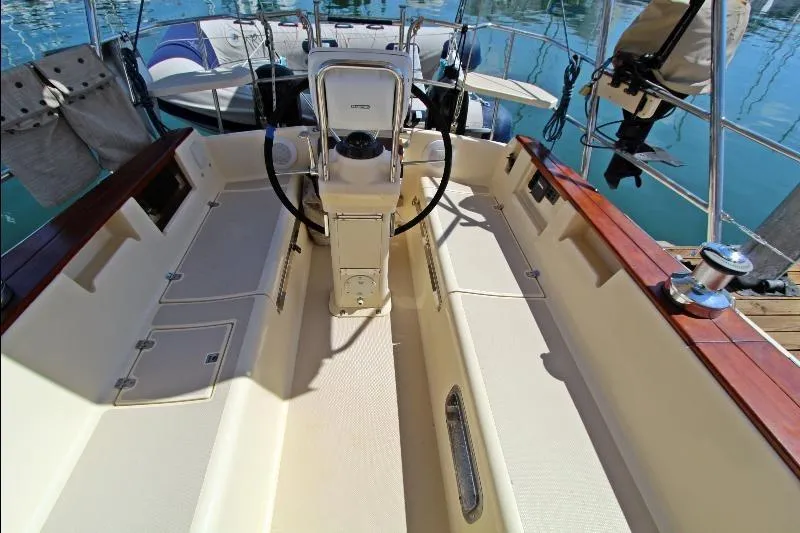  Yacht Photos Pics Cockpit of a 1999 Island Packet 380 sailboat with steering wheel and seating.