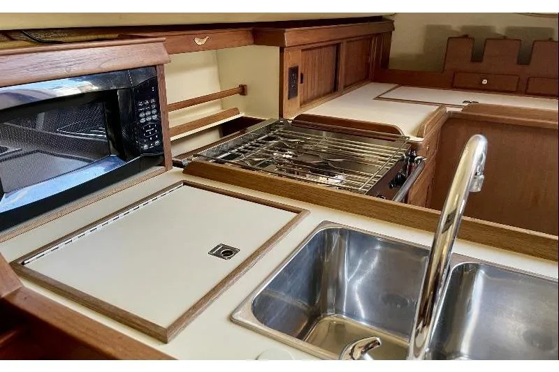  Yacht Photos Pics Island Packet 380 yacht kitchen with sink, stove, and microwave, 1999 model.