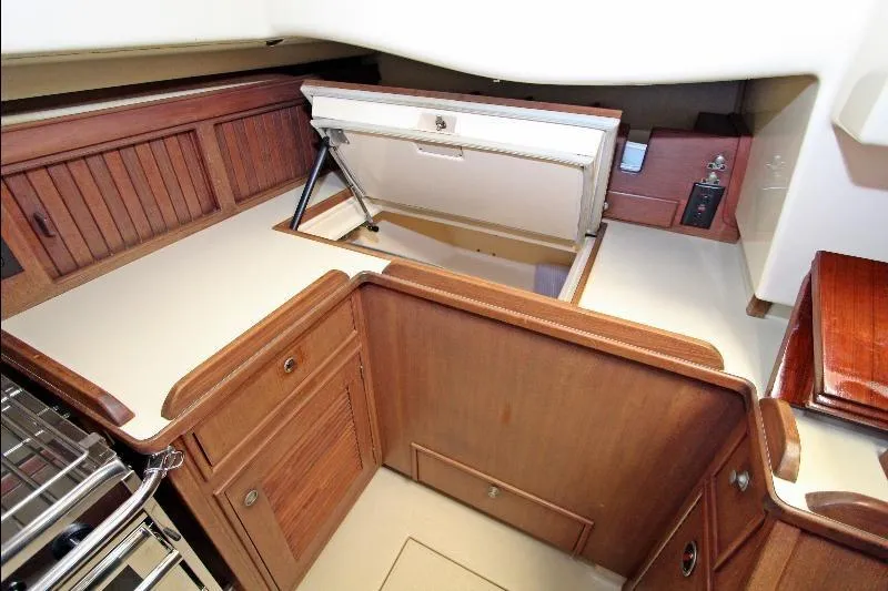  Yacht Photos Pics 1999 Island Packet 380 interior with wooden cabinetry and storage compartments.