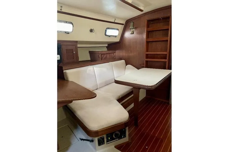  Yacht Photos Pics Interior of 1999 Island Packet 380 sailboat with cozy seating and wooden accents.
