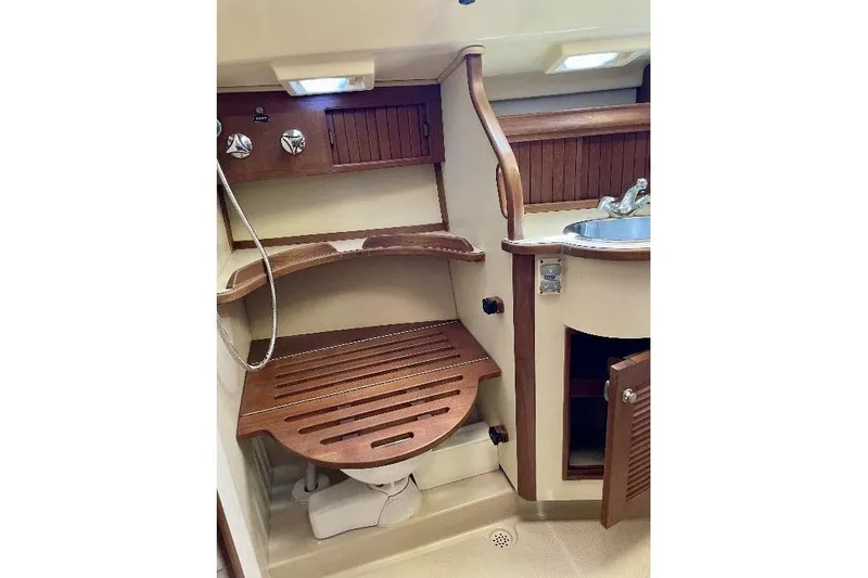  Yacht Photos Pics 1999 Island Packet 380 yacht bathroom with wooden accents and compact sink.