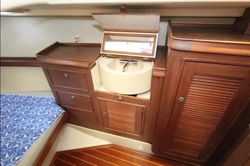  Yacht Photos Pics Interior of 1999 Island Packet 380 sailboat with wooden cabinetry and compact sink.