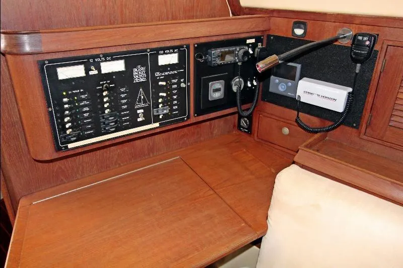  Yacht Photos Pics Navigation station of 1999 Island Packet 380 sailboat with control panels and communication equipment.