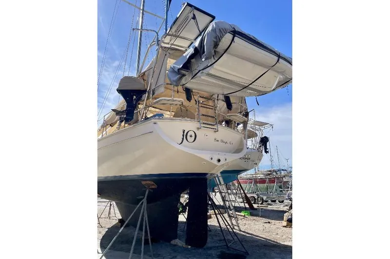  Yacht Photos Pics 1999 Island Packet 380 sailboat on stands, with dinghy, in a boatyard.