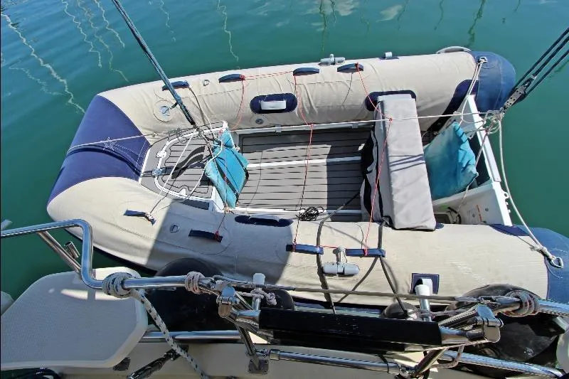  Yacht Photos Pics Inflatable dinghy on Island Packet 380 sailboat, 1999 model, docked in calm waters.