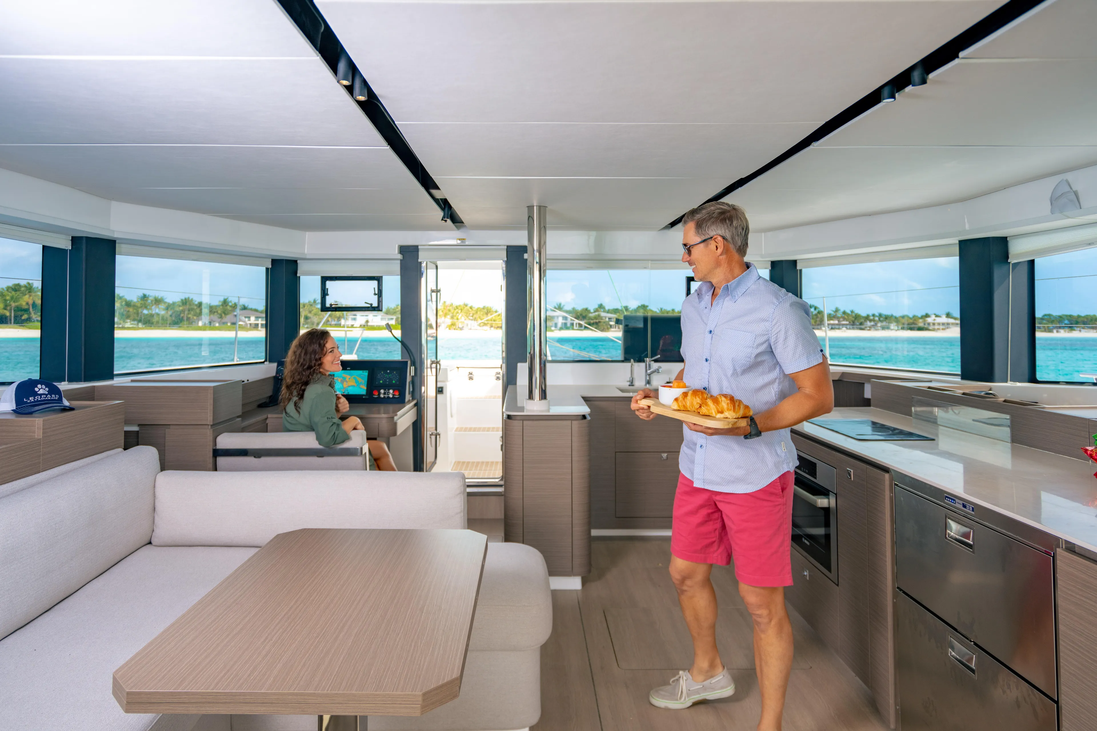 C1019 Yacht Photos Pics Modern interior of 2025 Leopard 46 yacht with people enjoying the spacious cabin.