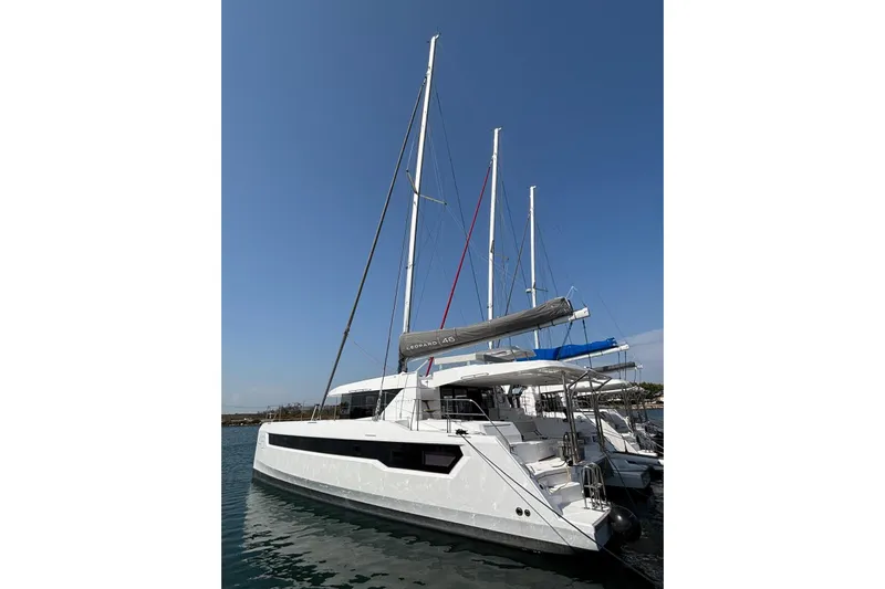 C1019 Yacht Photos Pics 2025 Leopard 46 catamaran docked in marina under clear blue sky.