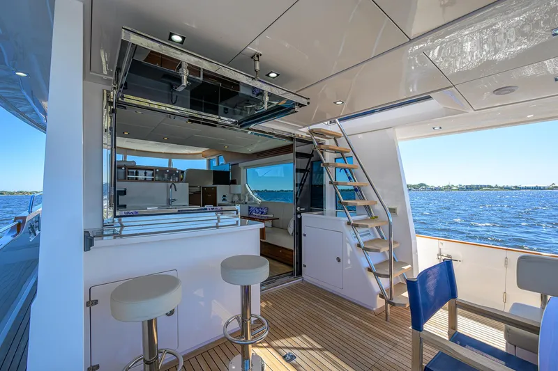 Fluke Yacht Photos Pics Luxurious 2020 Kadey-Krogen 54 Summit Motoryacht interior with bar stools and ocean view.