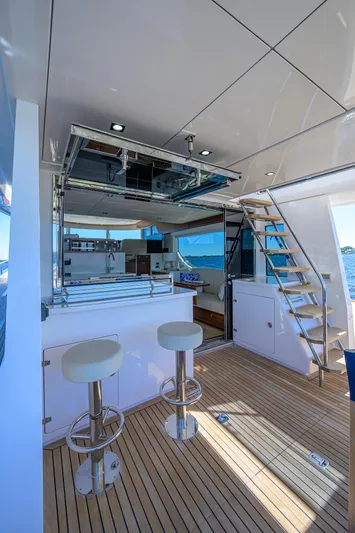 Fluke Yacht Photos Pics 2020 Kadey-Krogen 54 Summit Motoryacht interior with modern bar stools and staircase.