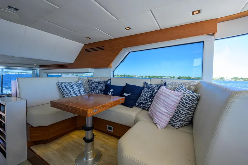 Fluke Yacht Photos Pics Luxurious interior of 2020 Kadey-Krogen 54 Summit Motoryacht with plush seating and scenic view.