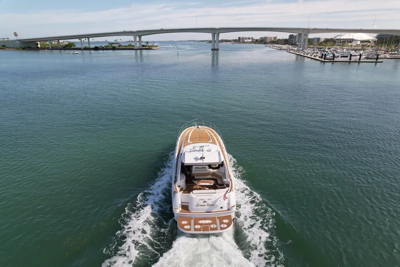  Yacht Photos Pics Sea Ray 510 Sundancer 2001 cruising under a bridge on a sunny day.