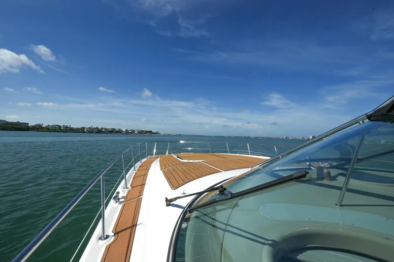  Yacht Photos Pics 2001 Sea Ray 510 Sundancer cruising on a sunny day, showcasing sleek deck design.