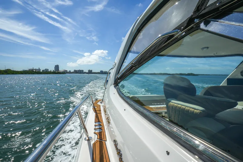  Yacht Photos Pics 2001 Sea Ray 510 Sundancer cruising on a sunny day, city skyline in background.